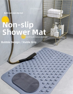 Close-up of gray non-slip bath mat with suction cups and specialized foot massage brush area