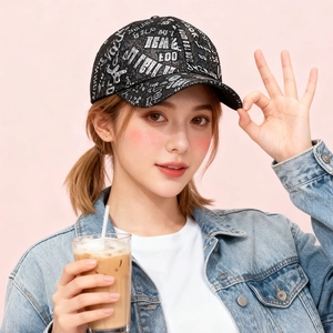 Close-up of black baseball cap with white graffiti lettering worn with denim jacket