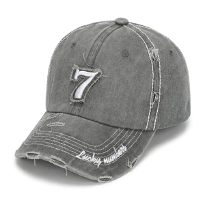 Detailed macro of the distressed baseball cap featuring a white number 7 patch and embroidery