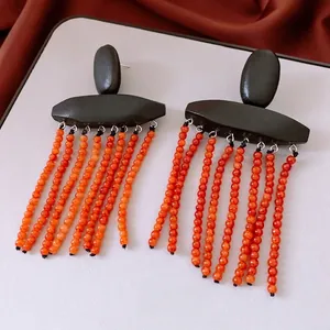 Ethnic wood beads tassel earrings with black geometric accents in vintage minimalist style