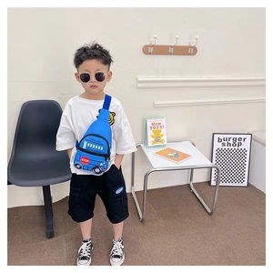 Blue school bus shaped kids chest bag with adjustable strap shown on a child model