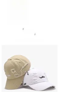 Detailed embroidery and metal rings on distressed washed cotton baseball caps