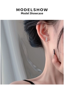Close-up of S999 sterling silver knot earrings with micro-set zircon on model ear