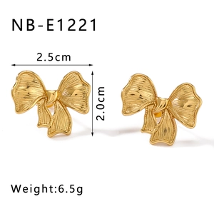 Detail view of golden bow earrings with measurements 2.5cm width and 2.0cm height
