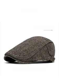 Detail of dark green herringbone tweed flat cap with adjustable side metal buckle