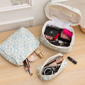 Three-piece floral quilted cosmetic bag set featuring a carry-all, pouch, and lipstick case