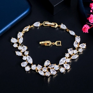 Sparkling zircon asymmetric leaf bracelet in gold finish for weddings and gifts