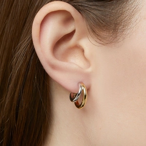 Two-tone 18k gold plated stainless steel double hoop earrings worn by a model