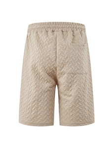 Detail view of khaki knit shorts featuring textured herringbone pattern and back pocket