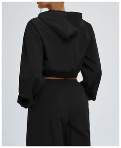 Rear view of black windproof hooded sports jacket with elastic hem and matching pants
