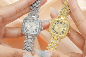 Macro view of square dial gold and silver watches with crystal encrusted bracelet straps