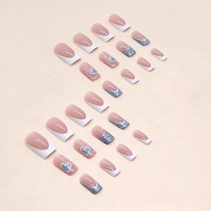French tip press-on nails with blue glitter and heart patterns on 24-piece nail set