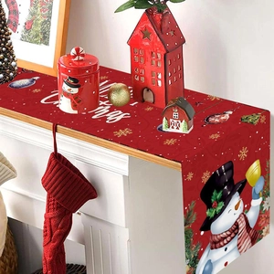 Red Christmas table runner featuring a snowman and Merry Christmas text on a mantel
