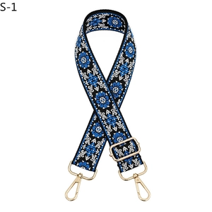 Detail of adjustable floral strap in blue and black with gold hardware and hooks