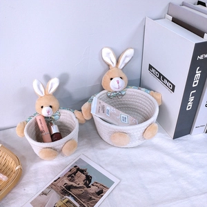 Macro detail of two nested woven cotton rope baskets with cute rabbit ears design