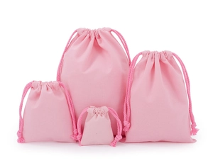 Four pink cotton drawstring bags in various sizes for organized storage and eco packaging