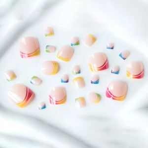 Rainbow wave French press-on toenails with vibrant colorful lines on nude pink base