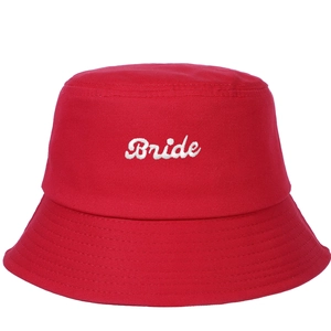 Detail of red cotton bucket hat featuring white Bride embroidery for wedding parties