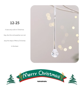 Close-up of clear crystal icicle ornament with inner bubble detail for Christmas tree