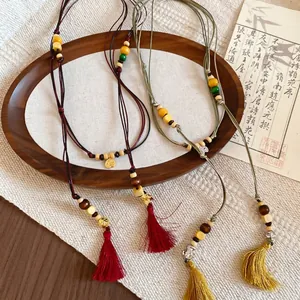 Ethnic wood bead necklace with silk tassels and woven cord in Neo-Chinese style