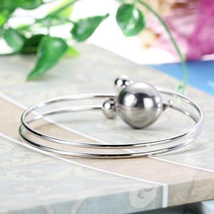 Elegant silver stainless steel double ring bangle featuring polished sphere decorations