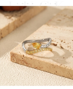 Detail of s925 silver snake-shaped ring with pear-cut yellow stone and pavé zircon