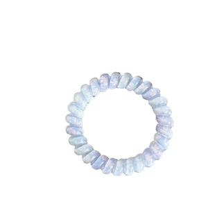 Lucky four-leaf clover floral telephone wire hair tie in blue and purple spiral design