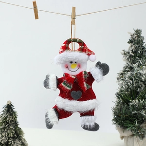 Detail of plush Christmas snowman hanging ornament with red plaid hat and gold string