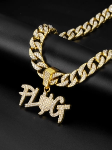 Detail of gold Cuban chain and PLUG pendant with iced out diamonds on dark reflective background