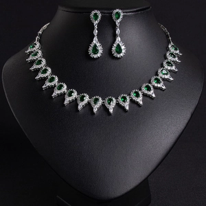 Elegant bridal jewelry set with emerald green stones and silver necklace and earrings
