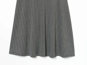 Vue détaillée du tissu gris à chevrons et de l'ourlet de la robe élégante en ligne A