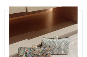 Close-up of luxury evening clutch bags with colorful rhinestones and crown clasps