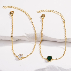 Gold-plated bracelet set with dark green and white oval cubic zirconia stones