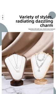 Close-up of velvet jewelry bust with layered silver necklaces and teardrop pendants