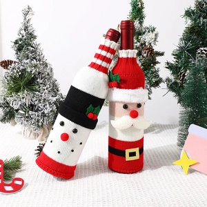 Close-up of festive knitted Santa and Snowman wine bottle covers for Christmas decor
