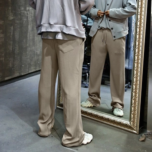 Detail view of khaki waffle texture pants showing front and back fit in a full mirror