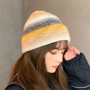 Women's vintage tie-dye knit beanie with warm yellow and grey gradient color pattern