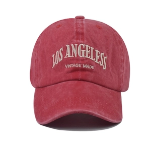 Close-up of Los Angeles white embroidery on vintage red washed cotton baseball cap