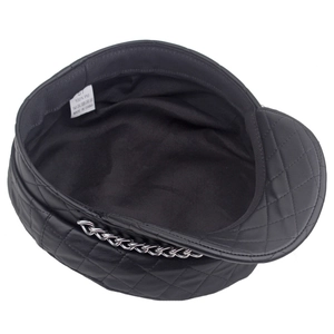 Detail of quilted PU leather newsboy cap with silver chain and internal fabric lining