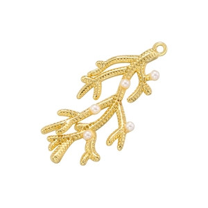 Vintage golden coral branch pendant with white pearls and metallic texture on white background