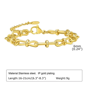 Macro view of 6mm stainless steel Figaro chain bracelet with 18K gold plating and stamp