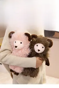 Plush baby sheep dolls in pink and brown being held to show soft texture and size reference