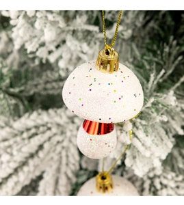 Macro view of white glittery mushroom Christmas tree ornament with red and gold details