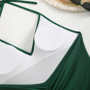 Detail of dark green halter swimsuit with mesh lining and removable round breast pads
