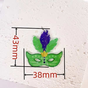 Macro view of green acrylic carnival mask pendant with fine glitter and 43mm x 38mm dimensions