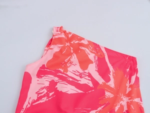 Detail of red and pink tropical print on lightweight chiffon shoulder of a summer dress
