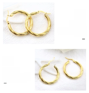 Close-up of twisted rope texture and clasp detail on gold-plated hoop earrings