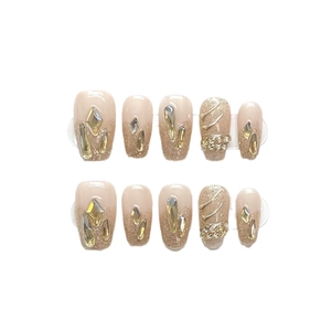 Handmade champagne glitter press-on nails with luxury rhinestones and gold leaf accents