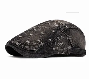 Detail of black washed denim ivy cap featuring quilted patterns and metal side buckle