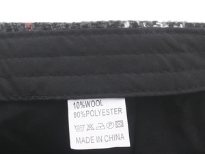 Macro shot of product label showing 10% wool blend material and neat inner stitching